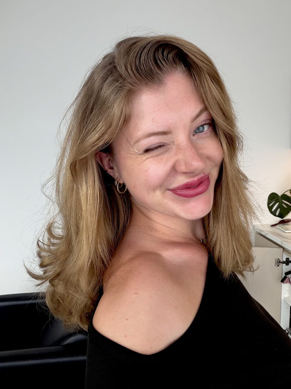 Abbi smiling and winking at the camera