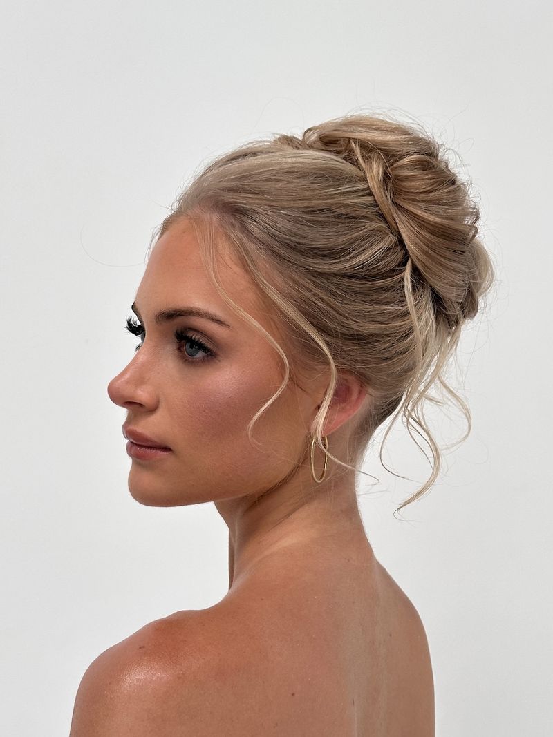 Soft blonde updo with loose tendrils