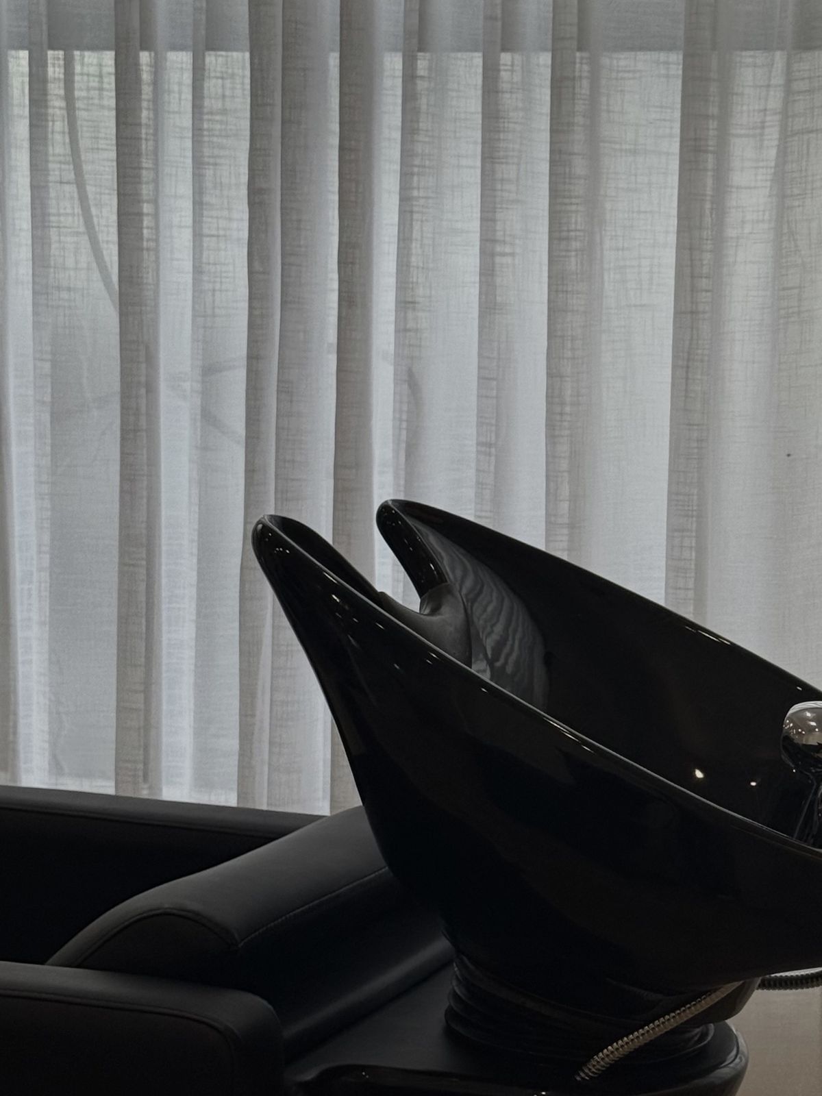 Basin by sheer linen curtains in the studio