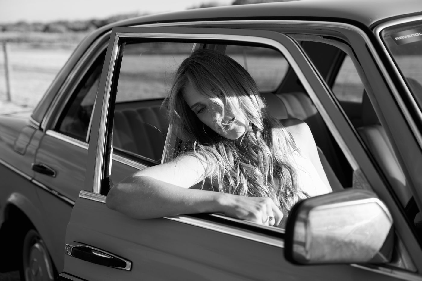 Editorial black and white portrait in a vintage car